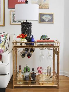 A bar cart doubles as a side table in this small apartment with big style #hgtvmagazine www.hgtv.com/...