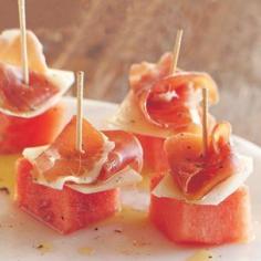 Ingredients:  1 1/4 lb. seedless watermelon  1/2 lb. serrano ham, thinly sliced  5 oz. Manchego cheese  Freshly ground pepper  Extra-virgin olive oil