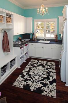 Must have that rug. Laundry room. Turquoise, black and white, chandelier and craftsman trim.