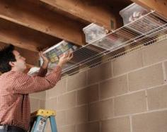 Attached wire shelving to floor joists for out of the way storage.