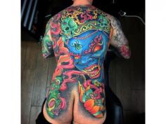 Full color tattoo on man's back with Raijin and Skull symbols, 