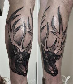 black buck tattoo on the leg