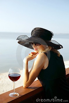 The Lady In A Hat With A Wine Glass Royalty Free Stock Image - Image: 20294566