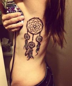 girl with dream catcher tattoo on her side