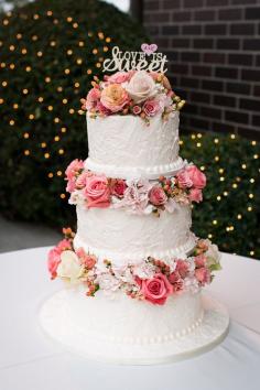 The pink fresh flowers on this cake MAKE it gorgeous!