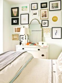 Eclectic #bedroom #gallery wall in front of a white wall and simple #bedding for a focal statement