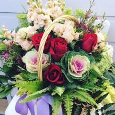 Cottage Flower Basket is a traditional basket arrangement in pink, white and red toned flowers 